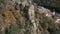 Aerial shot of team climbers climb up the cliff with beautiful town in the back