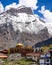 Aerial shot of a town located near high snowy mountains at Holy Buddhist Hindu site of Muktinath