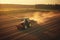 An aerial shot of a tractor plowing the fields at sunset, highlighting the modern machinery and technology used in farming