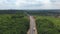 Aerial shot of traffic flow on renewal countryside highway. Drone flying over cars moving along asphalt freeway during