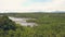 Aerial shot tropical palm forest and lake on mountain landscape on skyline. Drone view boats and ships in river flowing