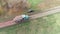 Aerial shot of a truck carrying gravel to repair the country road