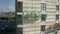 Aerial shot of unknown construction workers in suspended platforms or construction cradles