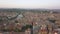 Aerial shot of Verona, Italy at sunset with typical Italian apartment rooftops, street crowds, Roman Colosseum Arena, Adige River,