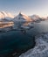 Aerial shot of very famous tourist destination called fredvang bridges and volandstinden mountain. Sunset over winter landscape