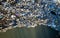 Aerial shot, waterfront scrap-heap pile of plastic rubbish