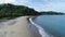 Aerial shot of wedding dress couple on the tropical beach Playa Arenillas in Costa Rica with a heart drawn into Sand