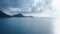 Aerial shot of a white yacht and dark mountains in a calm sea on a cloudy day Rodney Bay, Saint Lucia