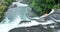 aerial shot of wild river with huge waterfall