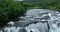 aerial shot of wild river with huge waterfall