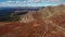 Aerial shot of winding road on top of the plateau of Mount Evans, Colorado, USA with valley and mountain range panorama