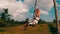 Aerial side view of woman on the swinging over beautiful rice fields background