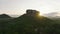 Aerial slide and pan footage of Lions Rock. Romantic view of popular tourist sight against rising sun. Sigiriya, Sri