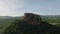 Aerial slide and pan footage of popular tourist destination, high Sigiriya Rock and vast forest all around. Sigiriya