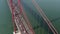 Aerial slider front view of dense multi vehicle traffic across famous large red suspension Ponte 25 de Abril bridge in