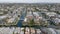 Aerial slider of Venice Canals surrounded by dense town development. Residential suburb of metropolis. Los Angeles