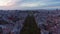 Aerial slow dolly in view of large public park Parque Eduardo VII with lush green vegetation in urban city center of