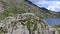 Aerial slow motion footage of female hiker exploring spectacular mountain landscape.