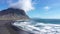 Aerial slow motion view of Vestrahorn mountains, Hofn and Atlantic ocean waves, Iceland