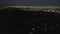 AERIAL: Slow Tilt Move over Hollywood Hills at Night revealing Los Angeles City Lights