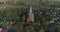 Aerial. Smooth point of interest drone shot of St. John church of Ramygala in Lithuania. Panorama of city in early autumn. 4k