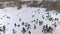 Aerial of snowboarders, skiers and mountain bikers having rest on top of snow hill