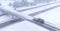 AERIAL: Snowplow cleans the highway overpass during a snowstorm in Washington