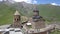 Aerial spectacular fast footage to Gergeti Trinity Church near village Gergeti in Georgia, under Mount Kazbegi