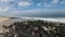 Aerial speed ramping fly over the ocean with beach waves and golden sand