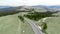 Aerial spinning shot Two cars moving on the road one by one in the mountains