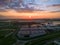 Aerial of a sprawling industrial estate adorned with a massive storage warehouse at sunset.