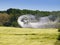 Aerial spraying over a field of wheat