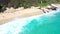 Aerial Still offshore over tropical clear blue ocean, with waves and sandy beach