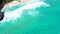 Aerial still view over clear turquoise blue ocean waves tropical Hawaii beach