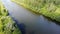 Aerial stock footage of river located among forest in summer at sunset