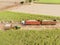 Aerial sugarcane field in Brazil. Tractor working, agribusiness