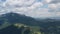 Aerial summer landscape of green forest and rocky mountains