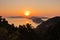 Aerial sunrise behind Alonisos island from the top of a hill in Skopelos