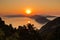 Aerial sunrise behind Alonisos island from the top of a hill in Skopelos