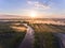 Aerial sunrise with fog at the tree tops in the rural countryside