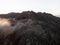 Aerial sunrise panorama of rolling clouds rock mountain hill at Cascada de Ezaro waterfall in Dumbria Galicia Spain