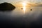 Aerial of Sunrise Silhouetting Ships and Island in Raja Ampat