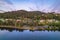 Aerial sunrise waterscape with mountain and houses