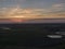 Aerial of sunset over agricultural meadowland and sea on the dutch island of Texel