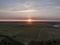Aerial of sunset over agricultural meadowland and sea on the dutch island of Texel