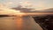 Aerial sunset over Lisbon sea bay with Belem tower