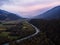 Aerial sunset panorama of river bend green meadows of Drau Valley at Stein Castle mountain landscape Carinthia Austria