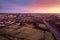 Aerial sunset scene with view on a highway and town residential and commercial area. Galway city, Ireland. Rich saturated warm and