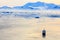 Aerial sunset surface of Neco bay surrounded by glaciers and mountains with antarctic cruise liner standing still among