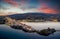 Aerial sunset view of the beautiful illuminated town of Andros island, Cyclades, Greece